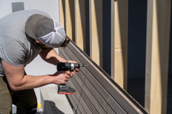 a-tough-construction-worker-applies-wooden-siding-2025-10-16-22-08-13-utc-scaled.jpg