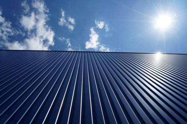 A low angle shot of a metal roof of a building on a sunny day
